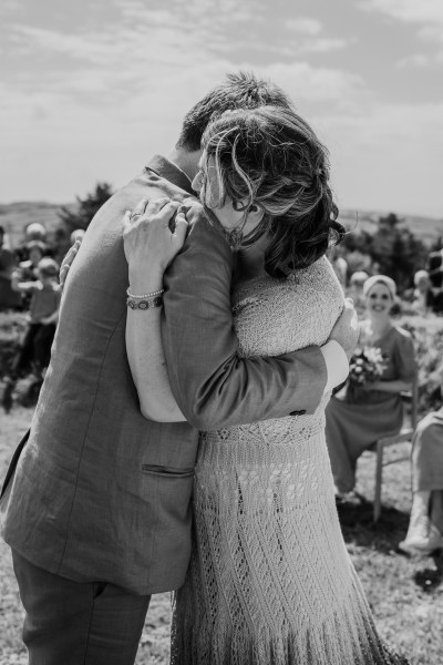 Bride and groom kiss at alter black and white pic