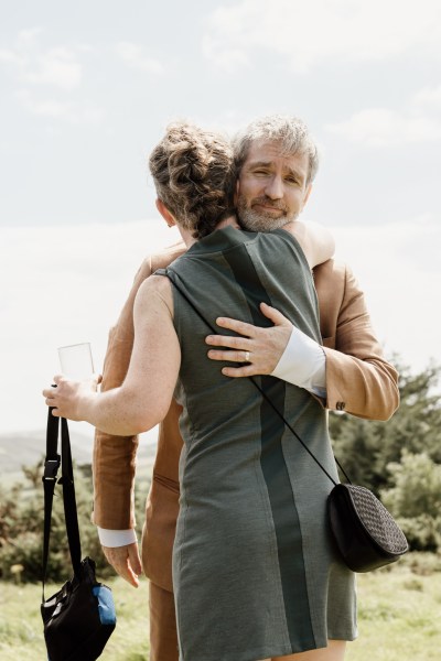 Groom hugs mother/guest