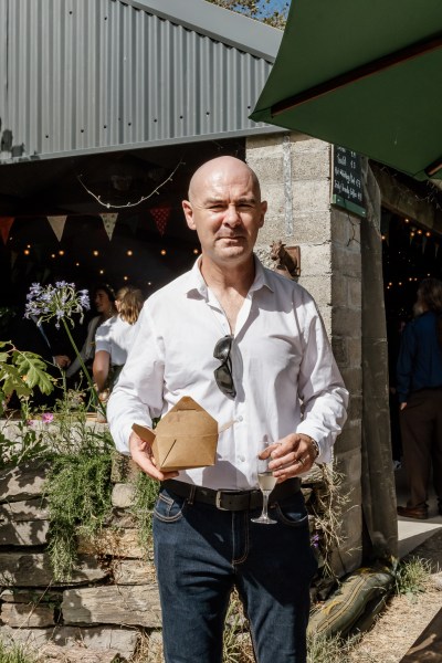 Man carrying box with food sunglasses on shirt