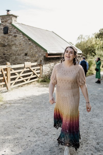 Bride walks along farm pathway