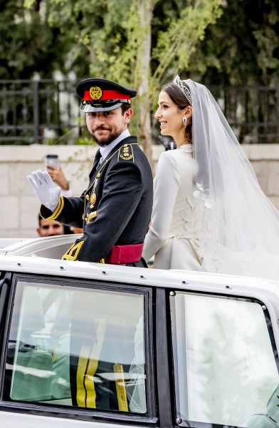 Jordan's Crown Prince Hussein (R) and his wife Saudi Rajwa al-Seif wave as they leave the Zahran Palace in Amman