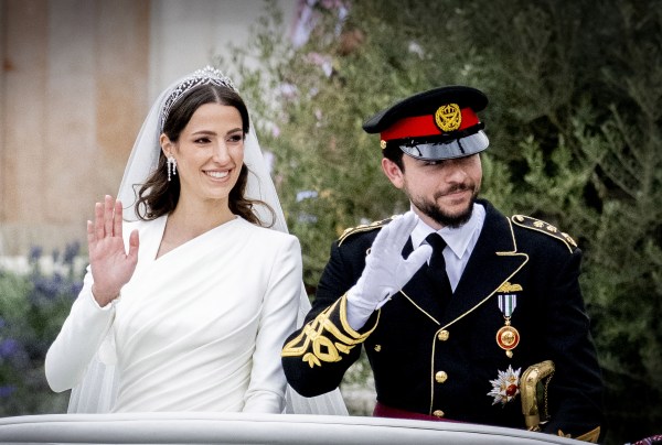 Jordan's Crown Prince Hussein (R) and his wife Saudi Rajwa al-Seif wave as they leave the Zahran Palace in Amman