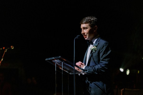 Guest speaking into microphone on podium