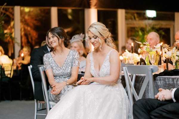 Bride seated listening to speeches