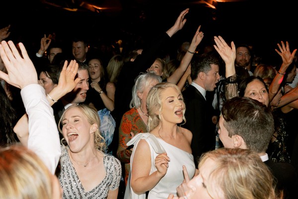 Bride and groom and guests dancing on the dancefloor