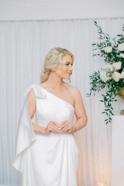 Bride stands on her own and poses