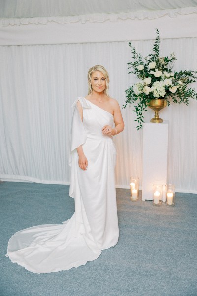 Bride stands on her own and poses