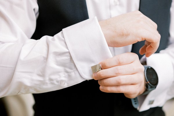 Groom fixes his cufflinks