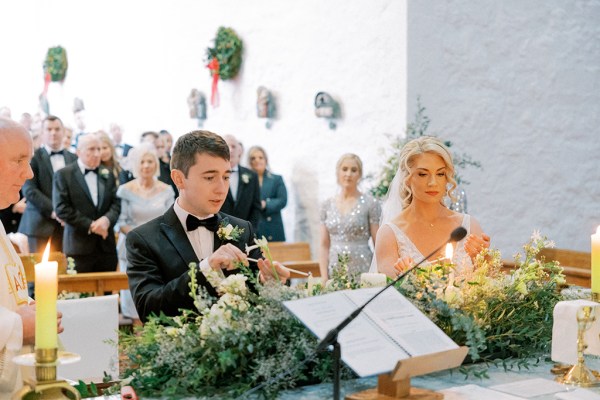 Groom in front of mic and priest