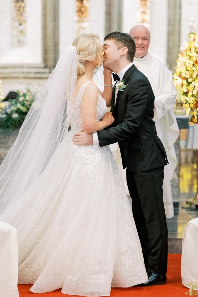 Bride and groom kiss kissing