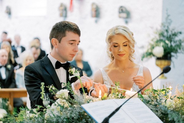 Bride and groom lighting a candle together