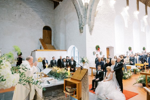 Guests along with bride and groom are seated during ceremony