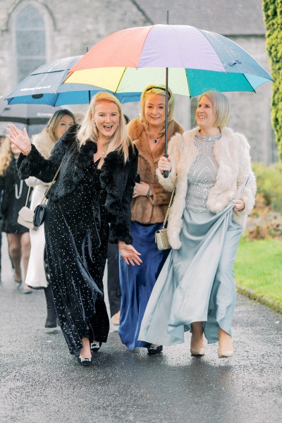 Guests walking along pathway with umbrella