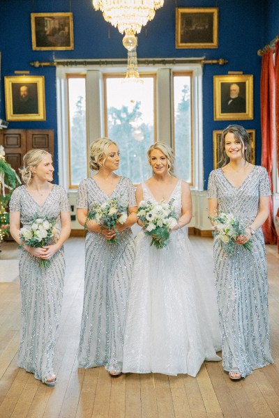 Bride and bridesmaids pose in portrait gallery elegant Victorian Room