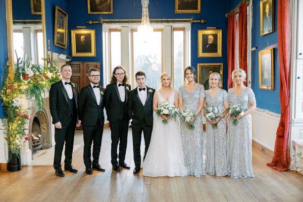 Bride bridesmaids groom and groomsmen pose in portrait gallery