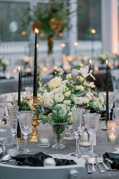 White roses cutlery candles lit black