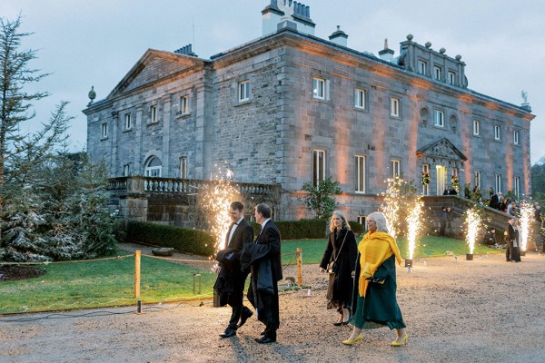 Guests walk along the pathway to wedding venue