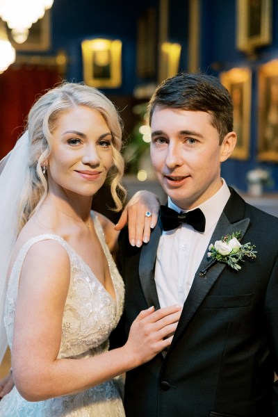 Bride and groom face the camera and smile