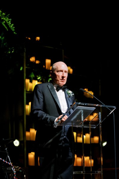 Father or guest gives speech at podium