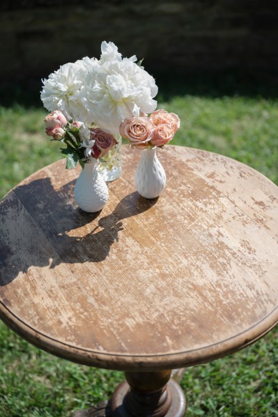 Table with flower vases white pink roses flowers