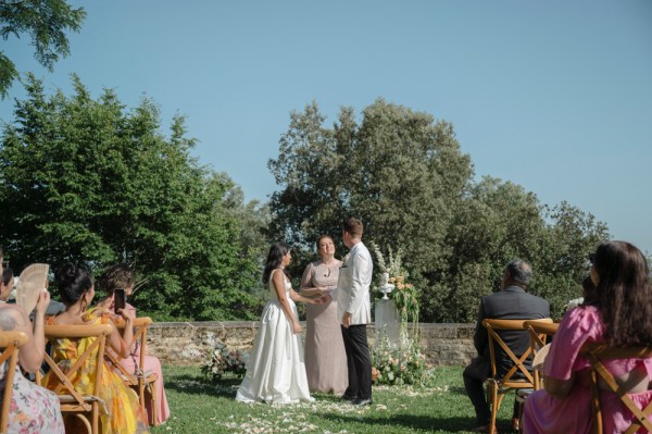 Bride and groom stand at alter with celebrant