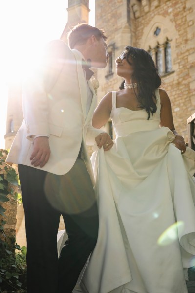 Sunlight exposure sunrays shining above couple as they go in for a kiss