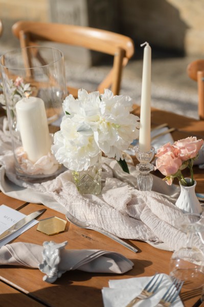 Up close white roses pink flowers table serviette cutlery