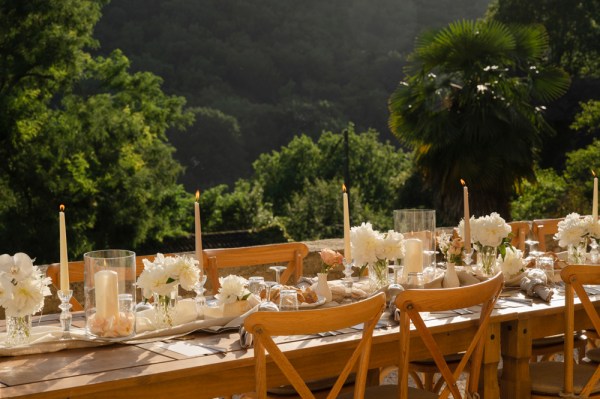 Table setting with trees and mountain view in background chairs