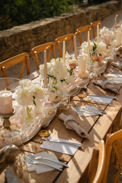 Empty table setting for guests wooden chairs and table candles