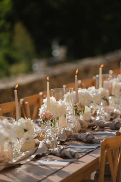 Empty table setting for guests wooden chairs and table candles