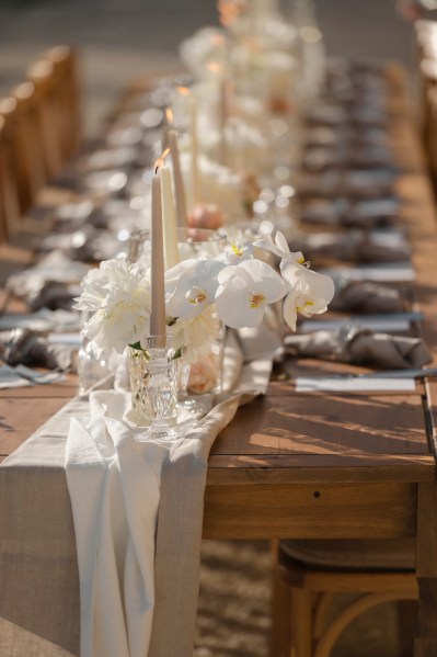 Empty table setting for guests wooden chairs and table candles