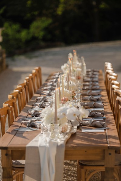 Empty table setting for guests wooden chairs and table candles