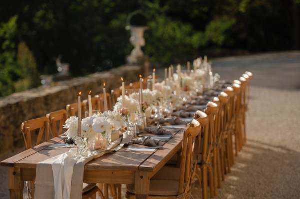 Empty table setting for guests wooden chairs and table candles