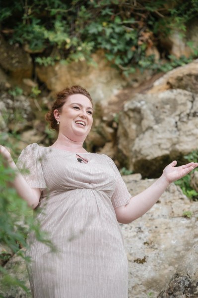 Joyous bridesmaids gestures to audience and guests