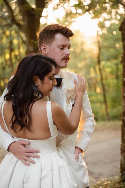 Bride and groom hold each other