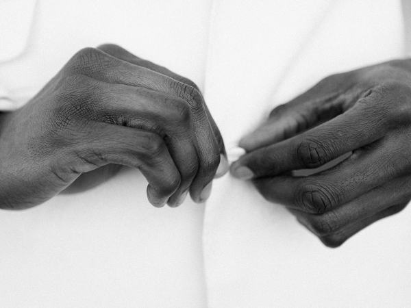 Close up of grooms hands and suit jacket