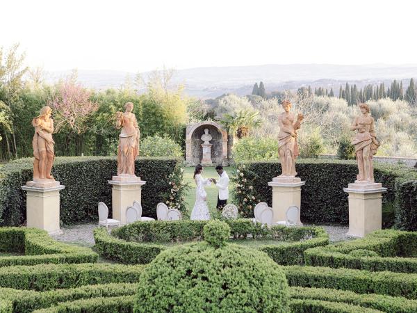 Garden view with bride and groom wide shot mountains in background