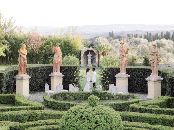 Garden view with bride and groom wide shot mountains in background