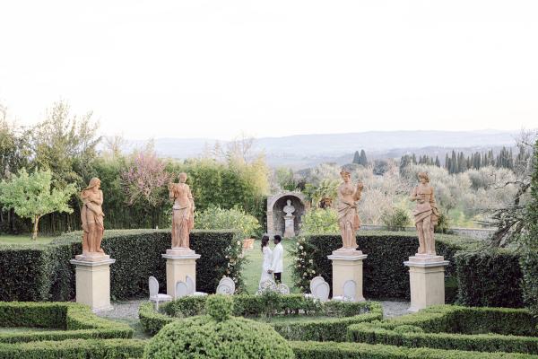 Garden view with bride and groom wide shot mountains in background