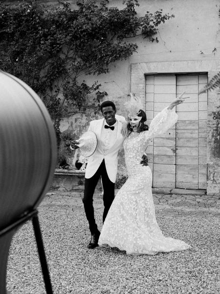 Bride and groom celebrate hands in the air black and white