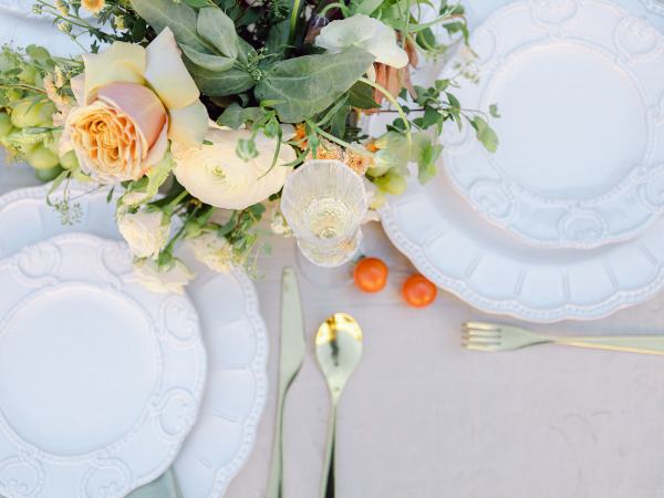 Cutlery flowers plates on table