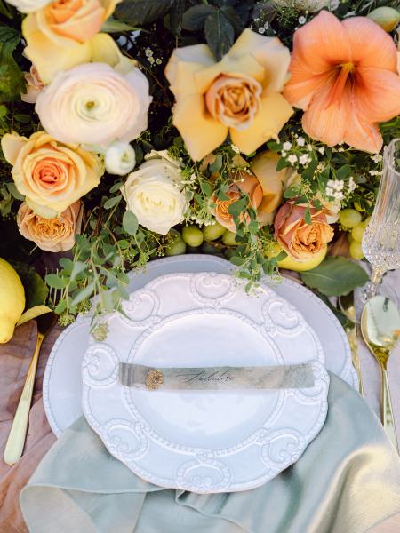 Cutlery flowers plates on table orange roses