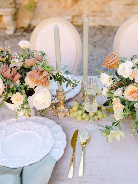 Cutlery flowers plates on table orange roses and tomatoes