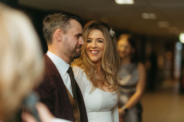 Bride and groom smile smiling at each other