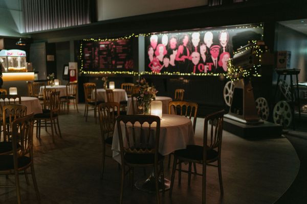 Seats dining room area dimly lit photos on wall