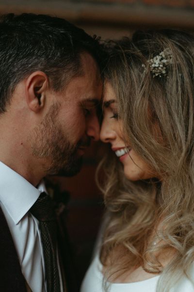 Close shot of bride and groom touching foreheads