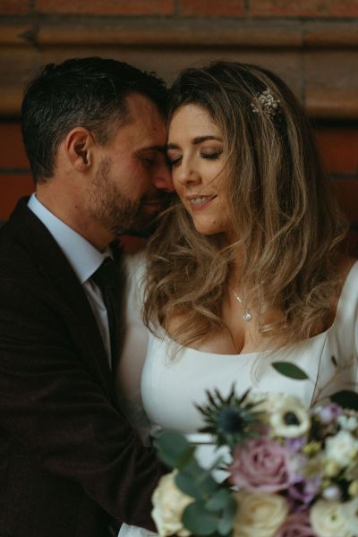 Close shot of bride and groom bouquet in view