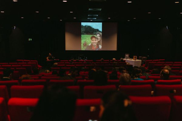 Cartoon is being played inside of cinema red seats in view