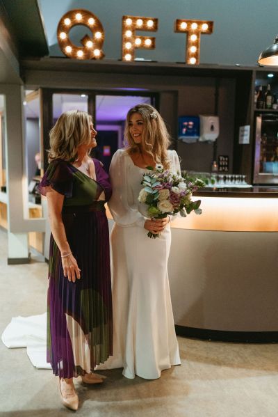 Bride with mother holding bouquet