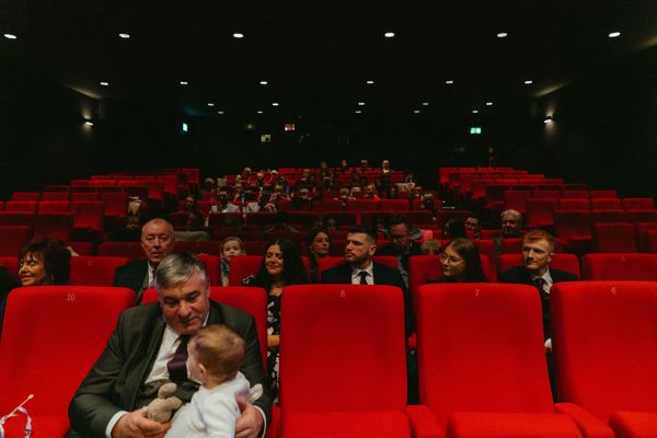 Audience members guests grandfather and his granddaughter little girl